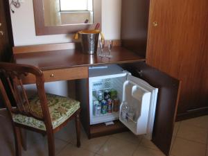 a small kitchen with a desk and a small refrigerator at Locanda Adele in Parghelia +33 photos
