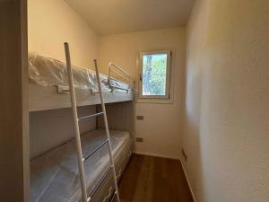 a small room with a bunk bed and a window at Apartment in Rosolina Mare 54758 in Rosapineta