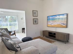 a living room with a couch and a flat screen tv at Pet-Friendly 3BR – Relax & Explore Beaches & Golf in Rotonda