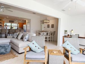a living room with a couch and chairs and a kitchen at Pet-Friendly 3BR – Relax & Explore Beaches & Golf in Rotonda