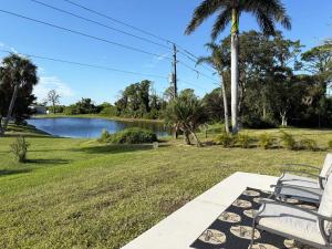 a couple of chairs sitting next to a lake at Pet-Friendly 3BR – Relax & Explore Beaches & Golf in Rotonda