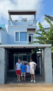 a group of people standing in front of a house at Villa 1985 in Buon Ma Thuot
