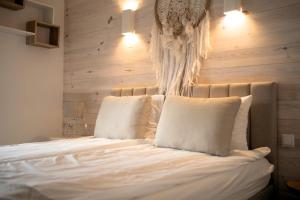 a bedroom with a bed with white sheets and pillows at Perfect View II - idealny widok na Marinę in Iława