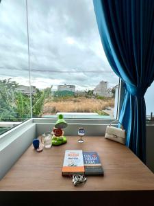 a table with a book on a window sill at Villa 1985 in Buon Ma Thuot +10 photos