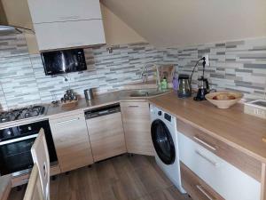 a kitchen with a sink and a washing machine at Holiday home in Balatonlelle 54843 in Balatonboglár Vasútállomás