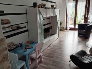 a living room with a table and a tv at Holiday home in Balatonlelle 54843 in Balatonboglár Vasútállomás +22 photos