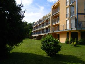 an apartment building with a bush in the yard at Apartment in Csopak - Balaton 54882 in Csopak