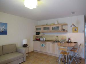 a kitchen with a couch and a table in a room at Apartment in Csopak - Balaton 54882 in Csopak +3 photos