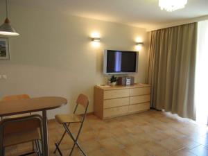 a living room with a table and a television on a dresser at Apartment in Csopak - Balaton 54882 in Csopak