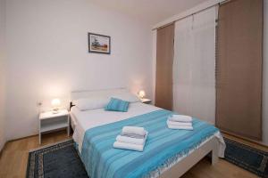 a bedroom with a bed with towels on it at Apartment in Crikvenica 41676 in Sopaljska +28 photos