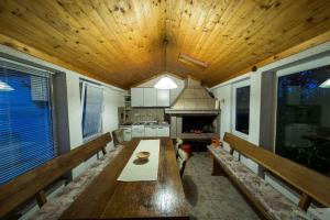 a kitchen with a large wooden table and a stove at Apartment in Crikvenica 41676 in Sopaljska