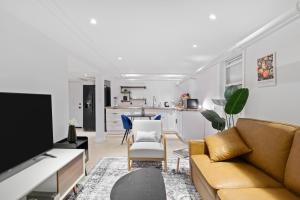 a living room with a couch and a dining room at 20 Mins to Times Sq. EWR | Cozy Apartment | Sleeps 4 in Jersey City