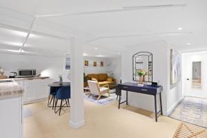 a kitchen and living room with a table and a couch at 20 Mins to Times Sq. EWR | Cozy Apartment | Sleeps 4 in Jersey City