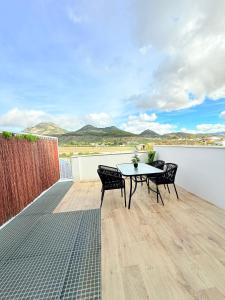 a patio with a table and chairs on a balcony at Alojamientos, Rafael muñoz in Alcaudete +28 photos