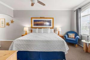 a bedroom with a bed and a blue chair at Coastal Cutie in Oceano +14 photos