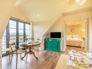 a living room with a table and a television and a bed at 1 Bed in Horsham 86961 in Rudgwick