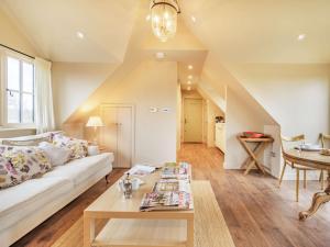 a living room with a white couch and a table at 1 Bed in Horsham 86961 in Rudgwick