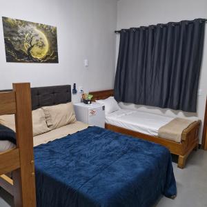 a room with two beds and a window at Suite privativo cafe hidro in Sao Jose do Rio Preto