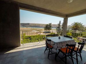 a table and chairs on a balcony with a view at Apartments in Lopar - Insel Rab 26467 in Lopar