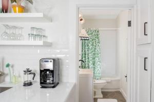 a white bathroom with a coffee maker on a counter at Downtown Walkable - 2 bed 1 bath King Bed in Appleton