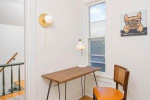 a room with a table and a dog picture on the wall at Downtown Walkable - 2 bed 1 bath King Bed in Appleton