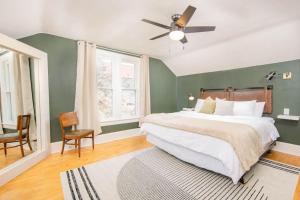 a bedroom with a large bed and a ceiling fan at Downtown Walkable - 2 bed 1 bath King Bed in Appleton
