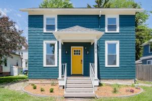 a blue house with a yellow door at Downtown Walkable - 2 bed 1 bath King Bed in Appleton +2 photos