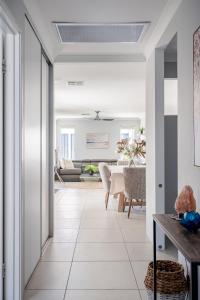 a living room with white tile flooring and a ceiling at Modern Bassendean Abode in Perth