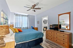 a bedroom with a bed and a dresser with a television at Peaceful Palace in Oceano