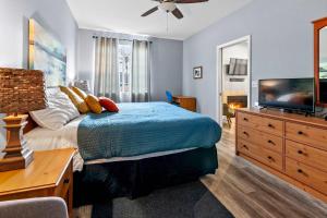 a bedroom with a bed and a flat screen tv at Peaceful Palace in Oceano +8 photos