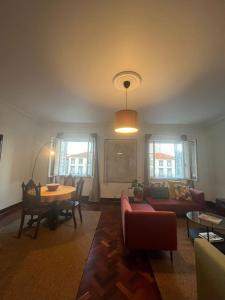 a living room with a couch and a table at AP Piso 2 inteiro · Portas Residence, o mais central de Ponta Delgada! in Ponta Delgada