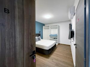 een kleine slaapkamer met een bed en een raam bij Mini Studios in Central Victoria in Victoria