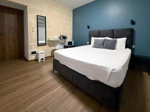a bedroom with a large bed and a desk at Mini Studios in Central Victoria in Victoria