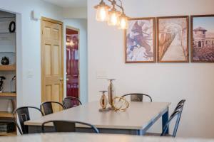 a dining room with a white table and chairs at Stevens Point Getaway - HUGE 5 bedroom Home 3 Full Bath in Stevens Point
