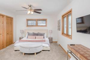 a bedroom with a bed and a ceiling fan at Stevens Point Getaway - HUGE 5 bedroom Home 3 Full Bath in Stevens Point