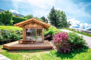 a wooden gazebo in the middle of a garden at Holiday Homes in Rennweg am Katschberg 47 in Aschbach