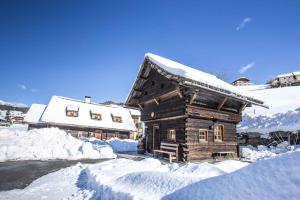 a log cabin with snow on the roof at Holiday Homes in Rennweg am Katschberg 47 in Aschbach