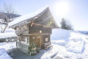 a small wooden cabin with snow on it at Holiday Homes in Rennweg am Katschberg 47 in Aschbach