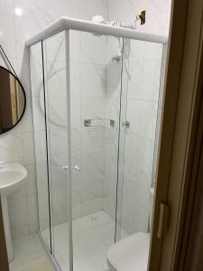 a glass shower in a bathroom with a toilet at Hospedaria Casa da Lia in Mucugê +59 photos