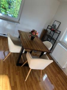 una mesa de comedor con sillas y un jarrón de flores en Nice 65m2 apartment in central Dachau, en Dachau