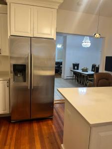 een keuken met een roestvrijstalen koelkast en een eetkamer bij Casino near in Malden