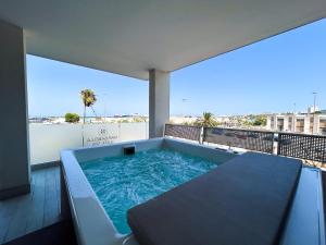 a hot tub on the balcony of a building at Marisabella Suite Spa 5 in Bari