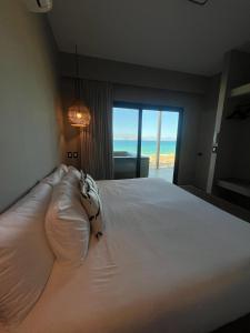 a bedroom with a bed with a view of the ocean at Private jacuzzi Ocean View Condo in La Ventana