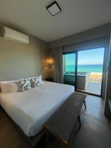 a bedroom with a large bed and a view of the ocean at Private jacuzzi Ocean View Condo in La Ventana