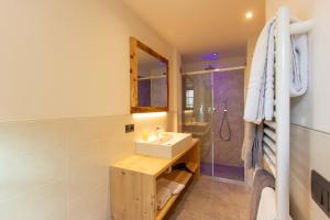 a bathroom with a sink and a shower at Ampas Francescato in Livigno +14 photos