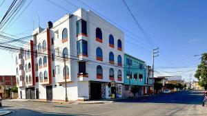 a white building on the side of a street at Solena Apartamentos Tacna in Tacna