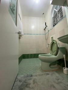 a bathroom with a toilet and a sink at Big Beautiful House in Pasig in Manila +24 photos