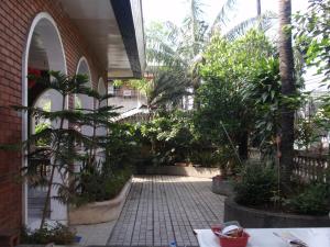 a courtyard with trees and plants in a building at Big Beautiful House in Pasig in Manila