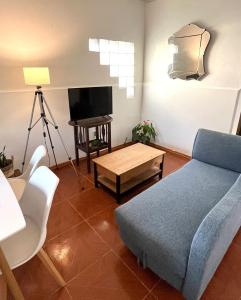 a living room with a couch and a table at Casa, gran parrillero a pocos minutos de sitios turísticos in Minas