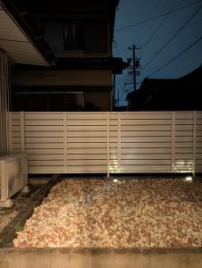 a fence with a bunch of rocks next to a house at ann近島 in Gifu +11 photos